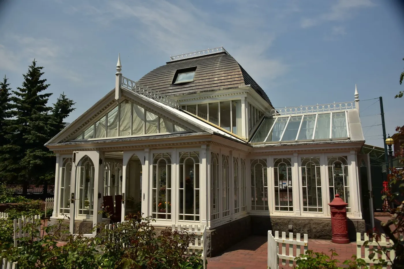 A white Victorian style conservatory with a glazed roof